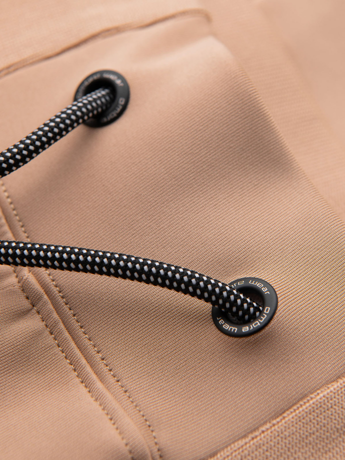 Męskie dresowe spodnie joggery z kontrastowymi lampasami – beżowe V4 OM-PASK-0229