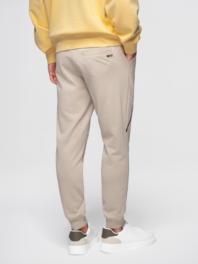 Męskie spodnie dresowe joggery - beżowe V3 OM-PASK-0280
