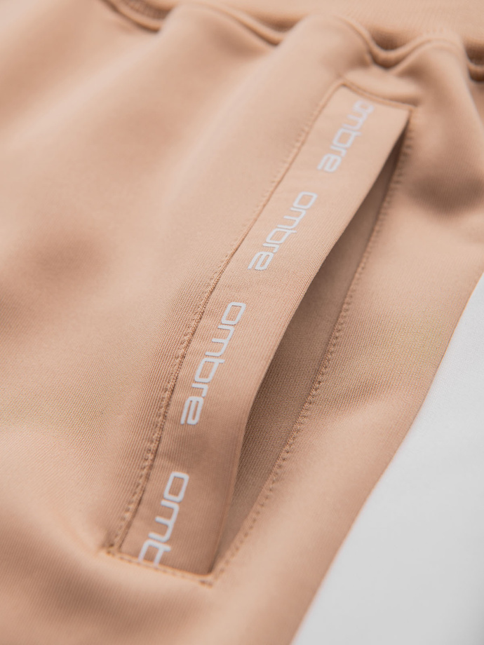 Męskie dresowe spodnie joggery z kontrastowymi lampasami – beżowe V4 OM-PASK-0229