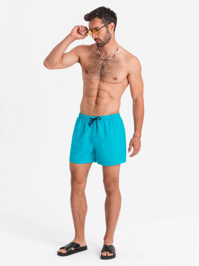Neonowe szorty męskie kąpielowe z efektem magic print – turkusowe V2 OM-SRBS-0147